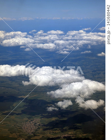 Panoramic Aerial View of White Clouds and Scenic Earth Landscape From Airplane Window Panoramic Aerial View of White Clouds and Scenic Earth Landscape From Airplane Window 141680442