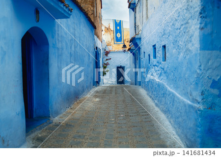 Narrow blue alley in painted Chefchaouen old town Narrow blue alley in painted Chefchaouen old town 141681434