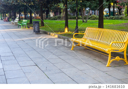 Colored benches in the park. Park infrastructure. Greenery in December. 141681610