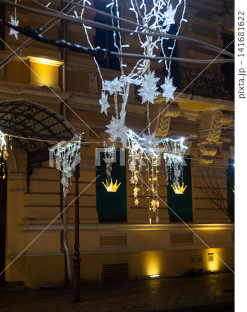 Lights on the street at night. City square on New Year's Day. Garlands for decoration. Holiday symbols. Networking garlands. Lights on the street at night. City square on New Year's Day. Garlands for decoration. Holiday symbols. Networking garlands. 141681622