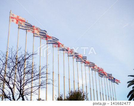 Many flags on flagpoles. Flags in the wind. State symbols. Many flags on flagpoles. Flags in the wind. State symbols. 141682477