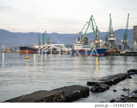 Port area on the Black Sea in winter. Sea cityscape at dusk. Batumi seaport. Industrial zone 141682518