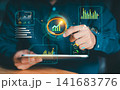 Businessman using digital magnifying glass to analyze financial dashboard and rising growth chart on tablet, market research and data analysis. 141683776