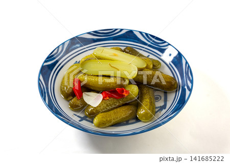 bowl of crunchy Russian pickled cucumbers gherkins with brine  , traditional appetizer 141685222