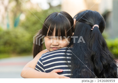 Happy Asian mother and little daughter hugging and piggybacking in the park, concept of motherhood and love Happy Asian mother and little daughter hugging and piggybacking in the park, concept of motherhood and love 141686959