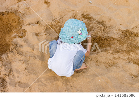 Asian Little Girl Playing With Sand on Beach During Summer Vacation 141688090