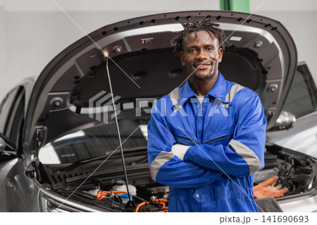 Portrait Happy Smiling Professional EV Car Service, worker Electricity Vehicle Maintenance in Garage Portrait Happy Smiling Professional EV Car Service, worker Electricity Vehicle Maintenance in Garage 141690693