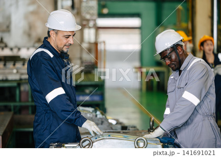 Professional lead engineer worker training young man to service injection mold in die casting plant Professional lead engineer worker training young man to service injection mold in die casting plant 141691021