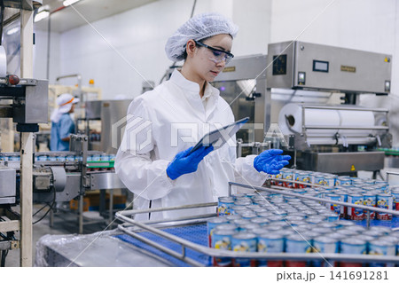 Food industry people worker, Quality control staff inspecting cannery food product in production line conveyor belt in food factory plant. 141691281