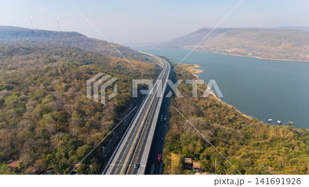 Drone shot aerial view landscape of the M6 motorway Expressway Nakhon Ratchasima Province - Bang Pa-in. Lam Ta Khong River and Mountain. Drone shot of scenic landscape rural place traffic. Nakhon Drone shot aerial view landscape of the M6 motorway Expressway Nakhon Ratchasima Province - Bang Pa-in. Lam Ta Khong River and Mountain. Drone shot of scenic landscape rural place traffic. Nakhon 141691926