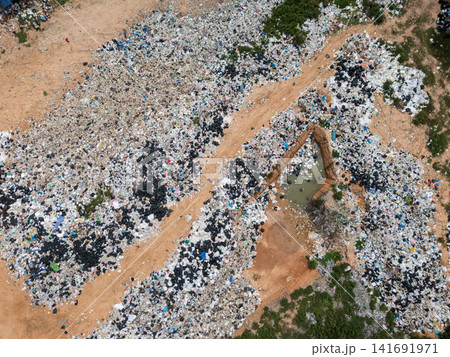 Aerial View of Landfill Site with Plastic Waste and Dirt Roads 141691971