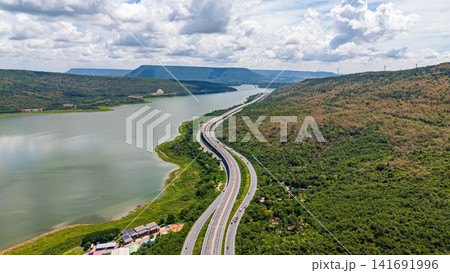 Drone shot The M6 motorway Nakhon Ratchasima Province - Bang Pa-in Lam Ta Khong River and Mountain. Motorway Korat Thailand Drone shot The M6 motorway Nakhon Ratchasima Province - Bang Pa-in Lam Ta Khong River and Mountain. Motorway Korat Thailand 141691996