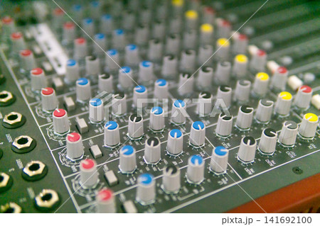 Audio mixing console with buttons and sliders. Selective focus. 141692100