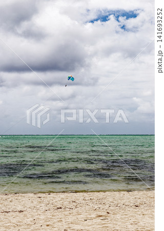 Parasailing adventure high above a turquoise tropical lagoon at Ile aux Cerfs, Mauritius Parasailing adventure high above a turquoise tropical lagoon at Ile aux Cerfs, Mauritius 141693252