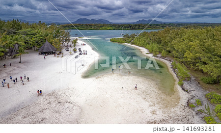 Aerial high angle shot of the sandbar beach, turquoise lagoon channel, and anchored boats at Ile aux Cerfs, Mauritius Aerial high angle shot of the sandbar beach, turquoise lagoon channel, and anchored boats at Ile aux Cerfs, Mauritius 141693281