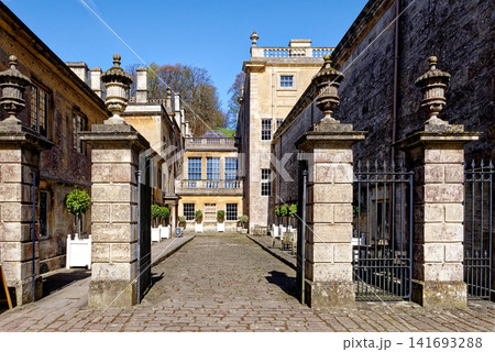 Grand stone gate pillars leading into the historic courtyard stable yard at Dyrham Park, England 141693288