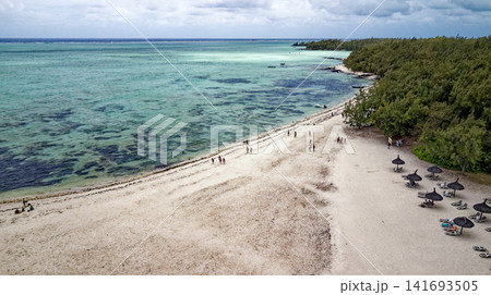 Aerial high angle shot of the sandbar beach, turquoise lagoon channel, and anchored boats at Ile aux Cerfs, Mauritius Aerial high angle shot of the sandbar beach, turquoise lagoon channel, and anchored boats at Ile aux Cerfs, Mauritius 141693505