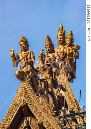 Close-up of carved deity statues on temple roof at Sanctuary of Truth, Pattaya Close-up of carved deity statues on temple roof at Sanctuary of Truth, Pattaya 141694411