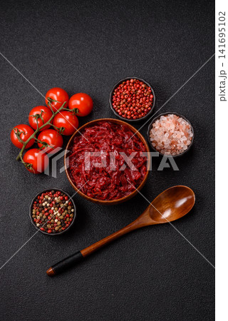 Grated beetroot with salt and spices as an ingredient for borscht or a vegan salad. Grated beetroot Grated beetroot with salt and spices as an ingredient for borscht or a vegan salad. Grated beetroot 141695102