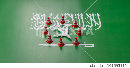 A mock up of airplane surrounded by no fly signs on a Saudi Arabia flag 141695113