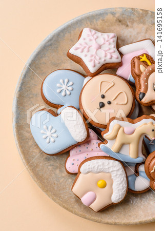 Gingerbread as a Christmas staple, sweet biscuits for the holiday. Gingerbread as a background Gingerbread as a Christmas staple, sweet biscuits for the holiday. Gingerbread as a background 141695158