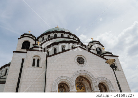 Front facade of Saint Sava Temple with domes and crosses in Belgrade Serbia. Concept of faith, architecture, tourism and cultural heritage Front facade of Saint Sava Temple with domes and crosses in Belgrade Serbia. Concept of faith, architecture, tourism and cultural heritage 141695227