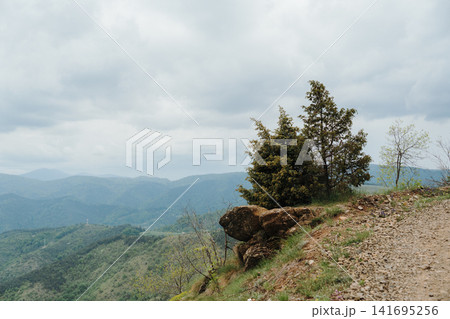 Dramatic storm clouds above mountain landscape on Stolovi Mountain in Serbia during spring. Concept of wilderness, weather and scenic adventure Dramatic storm clouds above mountain landscape on Stolovi Mountain in Serbia during spring. Concept of wilderness, weather and scenic adventure 141695256