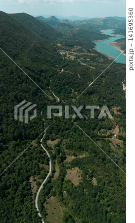 Aerial view of Zavoj Lake in Stara Planina National Park, Serbia, surrounded by green mountains and forested hills Aerial view of Zavoj Lake in Stara Planina National Park, Serbia, surrounded by green mountains and forested hills 141695360
