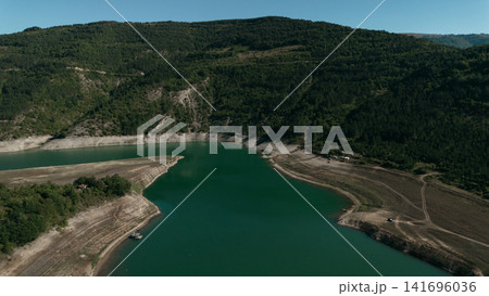 Aerial view of Zavoj Lake in Stara Planina National Park, Serbia, with turquoise water surrounded by green mountains Aerial view of Zavoj Lake in Stara Planina National Park, Serbia, with turquoise water surrounded by green mountains 141696036