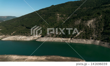 Aerial view of Zavoj Lake in Stara Planina National Park, Serbia, with turquoise water surrounded by green mountains Aerial view of Zavoj Lake in Stara Planina National Park, Serbia, with turquoise water surrounded by green mountains 141696039