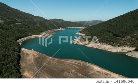 Aerial view of Zavoj Lake in Stara Planina National Park, Serbia, with turquoise water surrounded by green mountains Aerial view of Zavoj Lake in Stara Planina National Park, Serbia, with turquoise water surrounded by green mountains 141696040