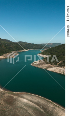 Aerial view of Zavoj Lake in Stara Planina National Park, Serbia, with turquoise water surrounded by green mountains Aerial view of Zavoj Lake in Stara Planina National Park, Serbia, with turquoise water surrounded by green mountains 141696041