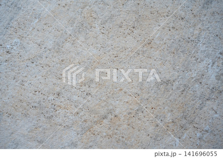 Light beige stone surface texture with subtle natural speckles and grain Light beige stone surface texture with subtle natural speckles and grain 141696055