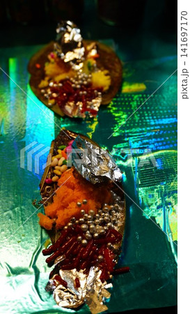 Ornate paan with candies and silver pearls on shimmering green surface, luxury dessert concept 141697170