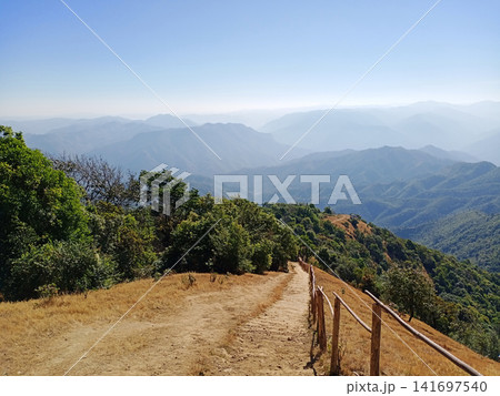 Landscape of The path descending from the summit is steep with a wooden handrail is provided as a crucial safety measure to prevent falls from mountain in Thailand Landscape of The path descending from the summit is steep with a wooden handrail is provided as a crucial safety measure to prevent falls from mountain in Thailand 141697540