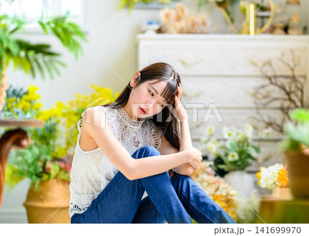 部屋で考え込む若い女性 141699970