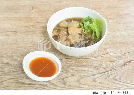 boiled braised beef meat and tendon couple organ in herb brown soup oncircle bowl dipping spicy chili sauce boiled braised beef meat and tendon couple organ in herb brown soup oncircle bowl dipping spicy chili sauce 141700433