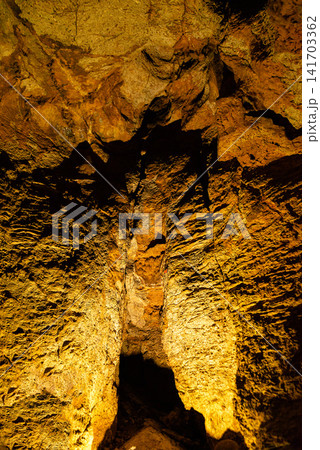 Natural stalactite and stalagmite formations inside an underground cavern 141703362