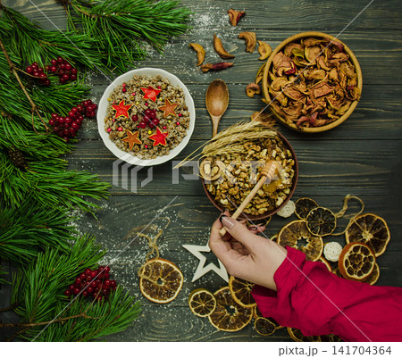 Traditional ukrainian christmas kutia preparation with viburnum on rustic table. Combining the past and the present through cultural traditions. 141704364