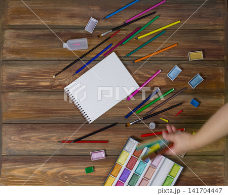 Clipboard mockup and art school stationery on a wooden background. Mock up for text. 141704447