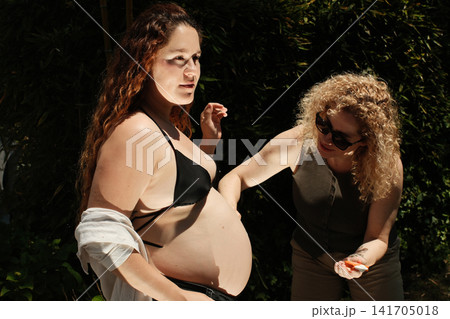 Pregnant woman enjoying a peaceful outdoor maternity lifestyle portrait Pregnant woman enjoying a peaceful outdoor maternity lifestyle portrait 141705018