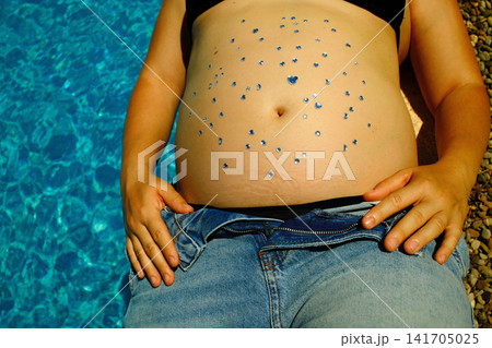 Pregnant woman enjoying a peaceful outdoor maternity lifestyle portrait Pregnant woman enjoying a peaceful outdoor maternity lifestyle portrait 141705025
