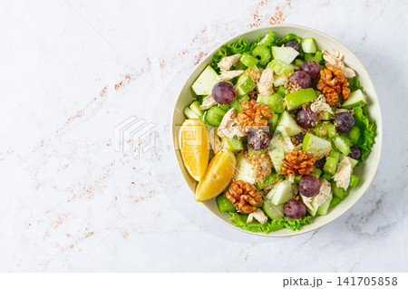Fresh Waldorf salad, celery stalk with chicken, apple and walnuts, grapes, herbs, homemade, without people, Fresh Waldorf salad, celery stalk with chicken, apple and walnuts, grapes, herbs, homemade, without people, 141705858