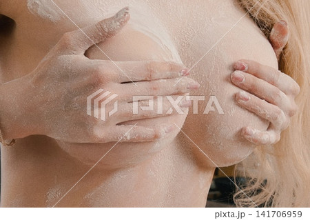 Woman's Hands Covering Chest Covered in White Powder Woman's Hands Covering Chest Covered in White Powder 141706959