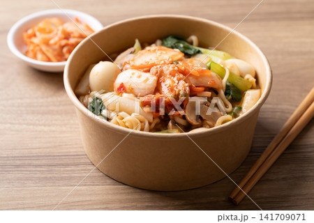 Instant noodle soup with kimchi, bok choy, champignon mushroom, quail egg and Tteokbokki Instant noodle soup with kimchi, bok choy, champignon mushroom, quail egg and Tteokbokki 141709071