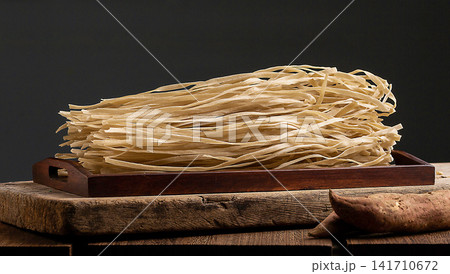 uncooked Flat Sweet Potato Noodles Starch Vermicelli Close Up uncooked Flat Sweet Potato Noodles Starch Vermicelli Close Up 141710672