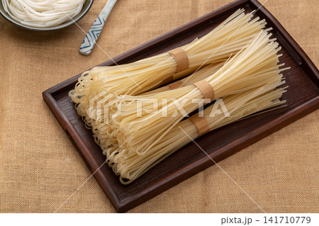 uncooked Flat Rice Noodles Dried Wide Rice Sticks 141710779