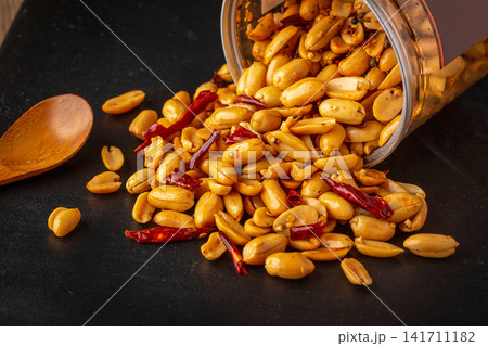 spicy roasted peanuts with chili peppers packed in sealed container spicy roasted peanuts with chili peppers packed in sealed container 141711182