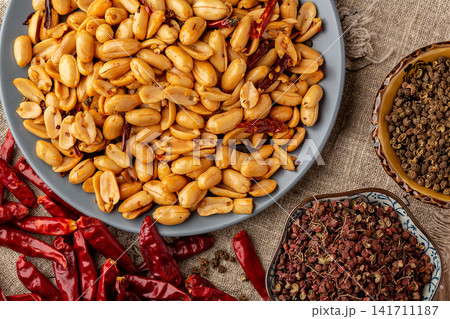 spicy roasted peanuts with chili peppers packed in sealed container spicy roasted peanuts with chili peppers packed in sealed container 141711187