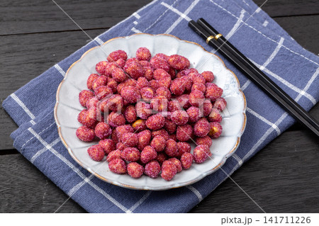 purple coated crispy peanuts served in small plate 141711226